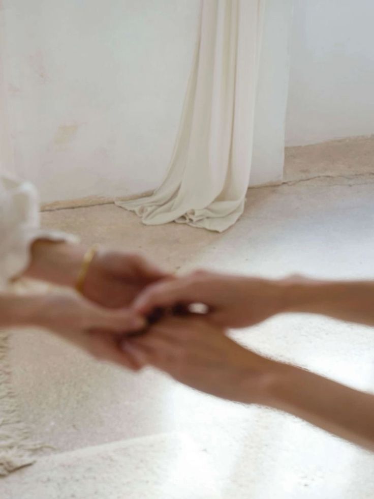 Hands joined in a bright, calm space